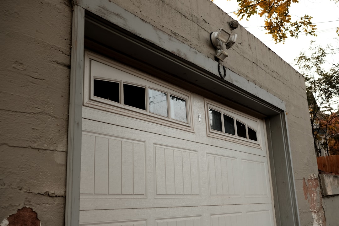 White sectional garage door on a brick house